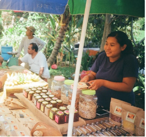 Picture of a woman at a food stand selling goods